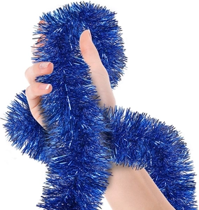 Close-up of shiny blue tinsel garland being held and wrapped for festive decoration