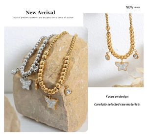 Detail view of butterfly pendant beaded bracelet with gold and silver crystal settings