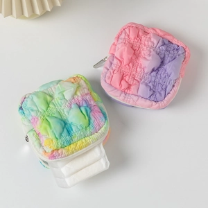 Detail of square quilted organizer bags with gradient tie-dye pattern and zipper closure