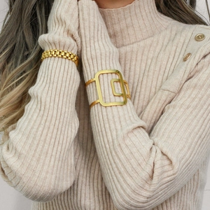 Close-up of 18K gold plated hollow cuff and chain bracelet on a female wrist