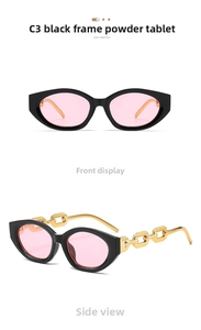 Detail of vintage cat-eye sunglasses with chunky gold chain temples and pink lenses
