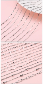 Macro view of various silver stainless steel chain styles including ring and wave designs