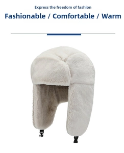 Detail of cream white winter trapper hat with soft faux fur lining and buckle strap