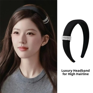 Close-up of black fabric padded headband with triple rows of pearls for hair styling