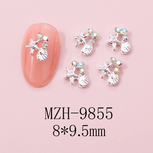Detailed view of starfish and seashell nail charms with iridescent rhinestones and silver base