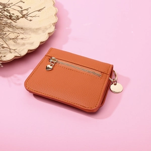 Orange lychee leather short wallet for women featuring a heart pendant and zipper pocket