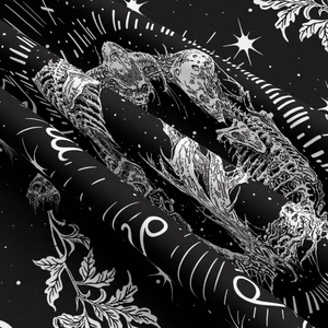 Close-up of black bohemian tapestry showing woven cotton texture and mystic skull prints