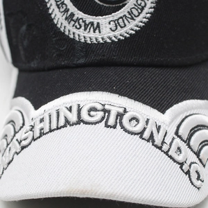 Close-up of Washington D.C. 3D embroidery on a minimalist black and white baseball cap