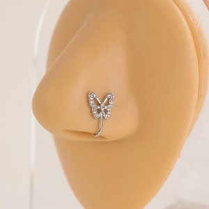 Close-up of silver butterfly fake nose ring with clear rhinestones on a skin-tone model