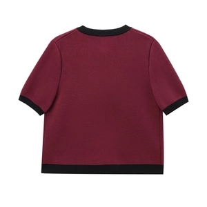 Detail view of the burgundy knit sweater's back with contrast black ribbed neck and cuffs