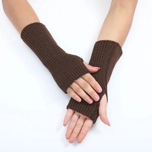 Detailed knit texture of brown fingerless gloves with thumb hole on model's wrist