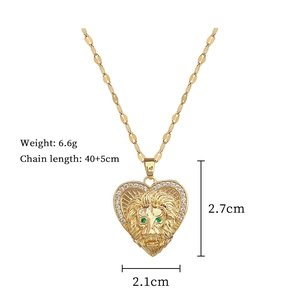Detail of gold heart lion necklace with green eyes and dimensions 2.7x2.1cm