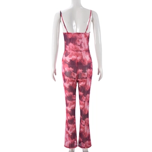 Detail of backless mesh jumpsuit featuring pink tie-dye print and thin shoulder straps