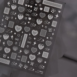 Detail of 3D embossed white lace heart and butterfly nail art stickers with relief texture