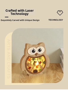 Detail of wooden owl light featuring intricate laser-cut forest and squirrel scene