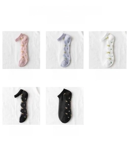 Detailed view of low cut socks with floral embroidery in pink, blue, white, and black colors