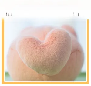 Close-up of pink plush cat keychain showing heart-shaped tail and fine stitching detail