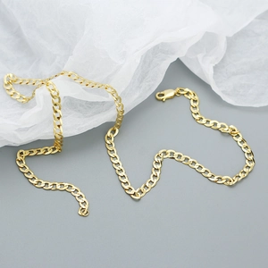 Detail shot of the flat gold curb chain necklace showing the secure clasp closure