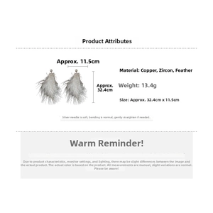 Detailed view of long grey feather earrings featuring copper and sparkling zircon accents