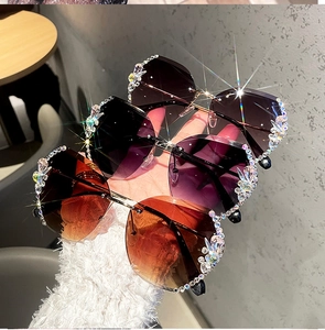 Detail of rimless butterfly sunglasses with sparkling crystals and gradient lenses