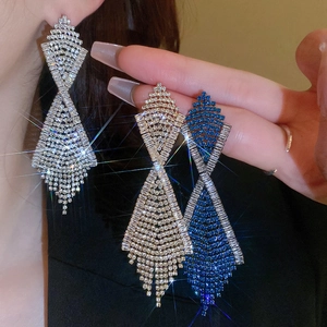 Macro detail of Art Deco tassel earrings with tiered diamond accents in three colors