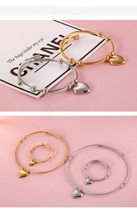 Detail view of heart charm bracelets and rings set with textured twisted steel wire