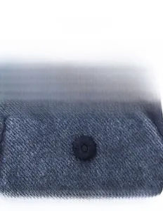Detail shot of the embroidered eyelet on the washed navy blue sandwich baseball cap