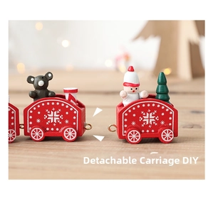 Detail of wooden Christmas train featuring snowman and bear with detachable carriages