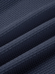 Macro shot of breathable dark blue waffle knit fabric showing fine texture and density