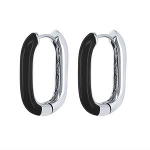 Detail view of oval silver and black enamel earrings with polished metallic finish