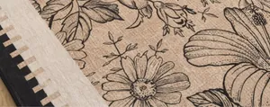 Detailed macro view of retro floral canvas texture and woven geometric patterns on the rug