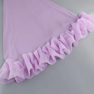 Detailed macro of the lilac dress hem featuring pleated chiffon ruffle trim and silky fabric