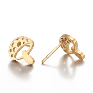 Macro view of gold mushroom stud earrings with hollow details and matte finish