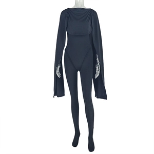 Detail of black sleeveless bodysuit with matching long sleeve shrug and textured fabric