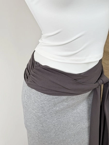Detailed close-up of color-block knit skirt with waist tie and soft fabric texture