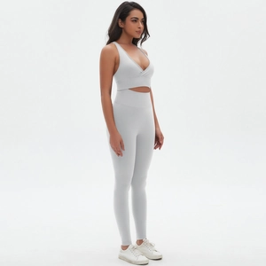 Detail view of seamless grey yoga set featuring cross V-neck top and high waist leggings