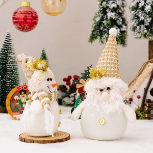 Festive plush snowman and gnome dolls with gold knit hats and white fur beard details