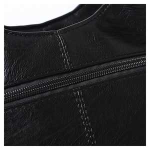 Detailed macro shot of high-quality lychee texture leather and durable zipper stitching