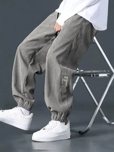 Detail view of grey corduroy cargo pants fabric texture with 01 Good Ideas label