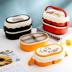 Detailed flat lay of Japanese-style double-layer plastic bento boxes on a lifestyle table