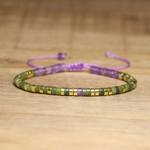 Detailed view of woven imperial stone bracelet with adjustable purple silk cord