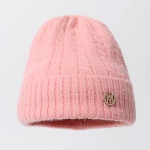 Pink chunky cable knit beanie with fleece texture and rhinestone letter M badge
