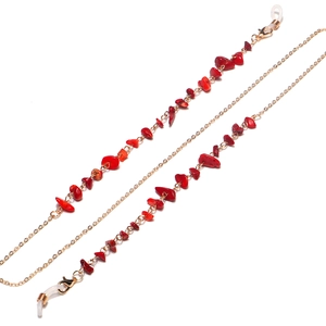 Close-up of gold chain eyewear strap with red natural stones and lobster clasps