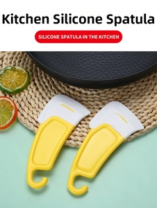 Close-up of yellow and white silicone kitchen scraper set with ergonomic hanging handle