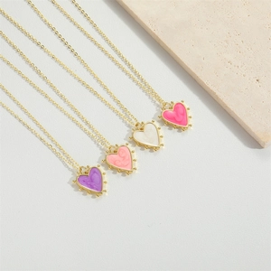 Detailed view of colorful heart-shaped oil drip necklaces on elegant stone background