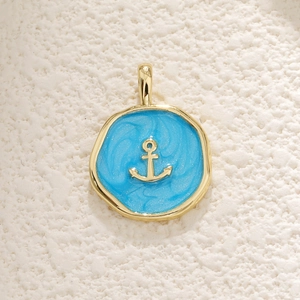 Golden nautical anchor charm with light blue glitter inlay and circular metal frame