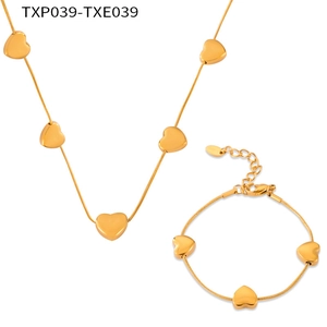 Detailed view of gold titanium steel heart pendant necklace and bracelet jewelry set