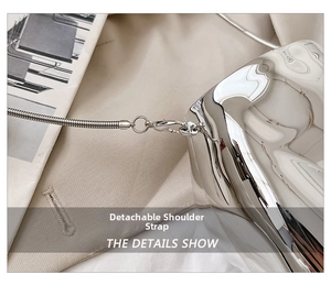 Detail of the silver metallic chain bag showing the detachable snake bone shoulder strap
