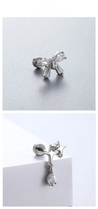 Macro detail of silver bow and star stud earrings with sparkling clear cubic zirconia