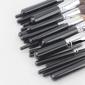 Detail of 30pcs professional makeup brush set with black glossy handles and silver ferrule